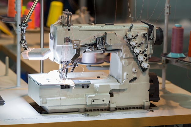 Sewing machine and cloth in cutting shop, nobody