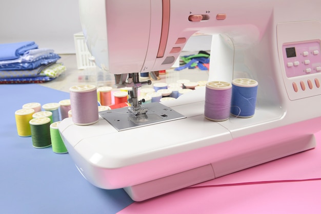 Photo sewing machine and colorful thread rolls for sewing, sewing and needlework concept.