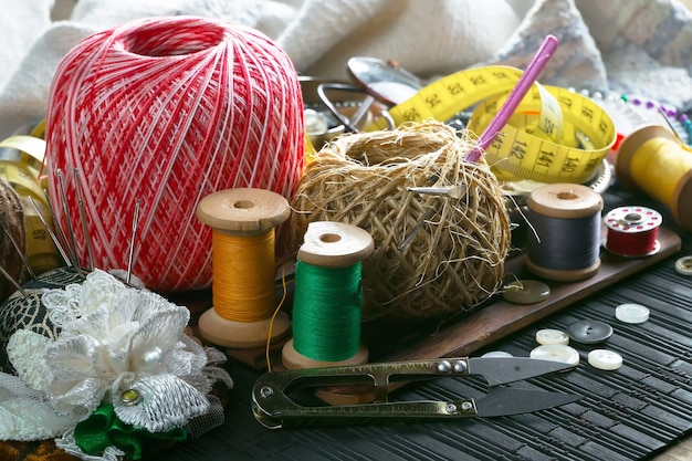 A sewing machine and a pair of sewing thread on a table.