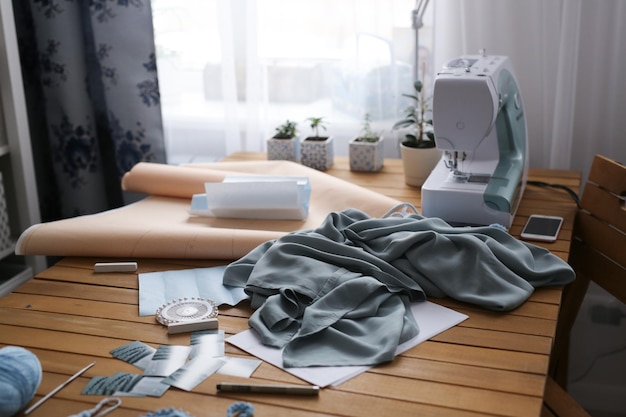 Sewing machine paper patterns and cloth on  desktop in workshop concept small sewing business