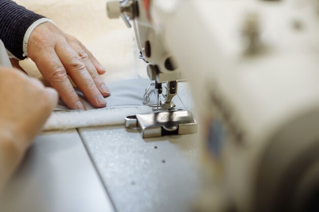 Sewing machine scribbling fabric. tailoring at the factory.