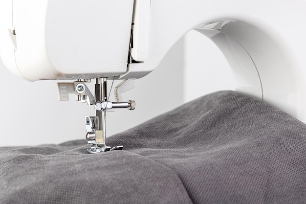 Sewing machine stitching fabrics needle in a round plan close up