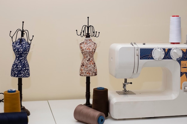 Sewing machine with fabric on table in tailor workshop