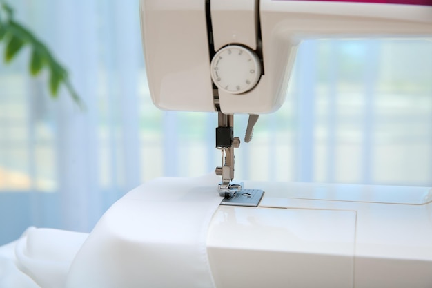 Sewing machine with textile near window closeup