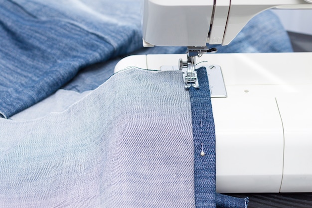 Sewing and needlework at home. Jeans recycling.