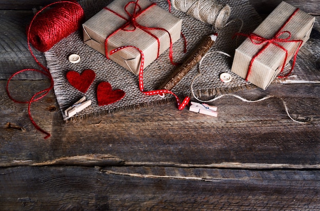 Sewing set: fabrics, threads, pins, buttons, tape and handmade hearts on burlap, sackcloth