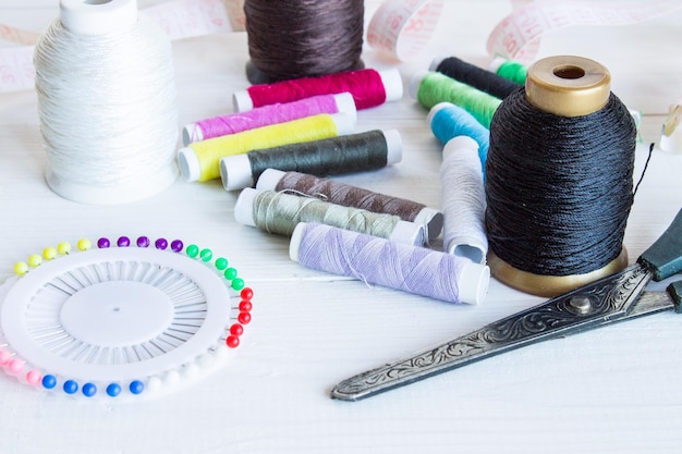 Sewing tools on a wooden background