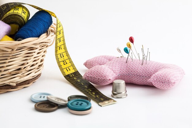 Sewing utensils, scissors, thread, buttons isolated on white background