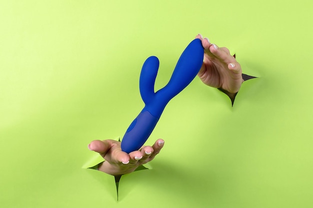 A sex toy on a green background Blue dildo Leisure for adults