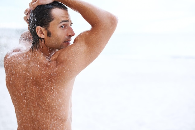 Sexiness is next to cleanliness Shot of a handsome young man enjoying a refreshing shower