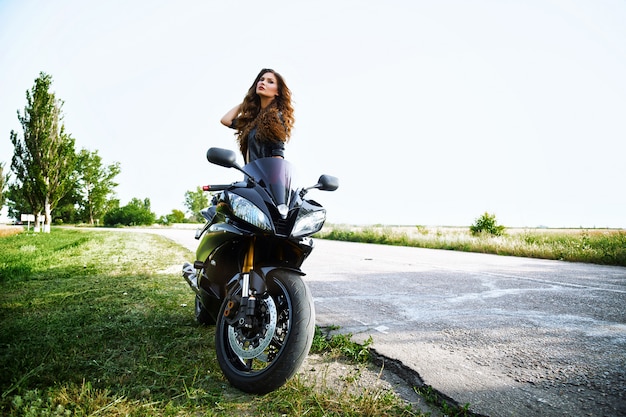 Sexual biker woman wearing black leather jacket