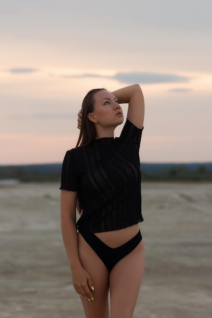 Sexual woman in black outfit on beach