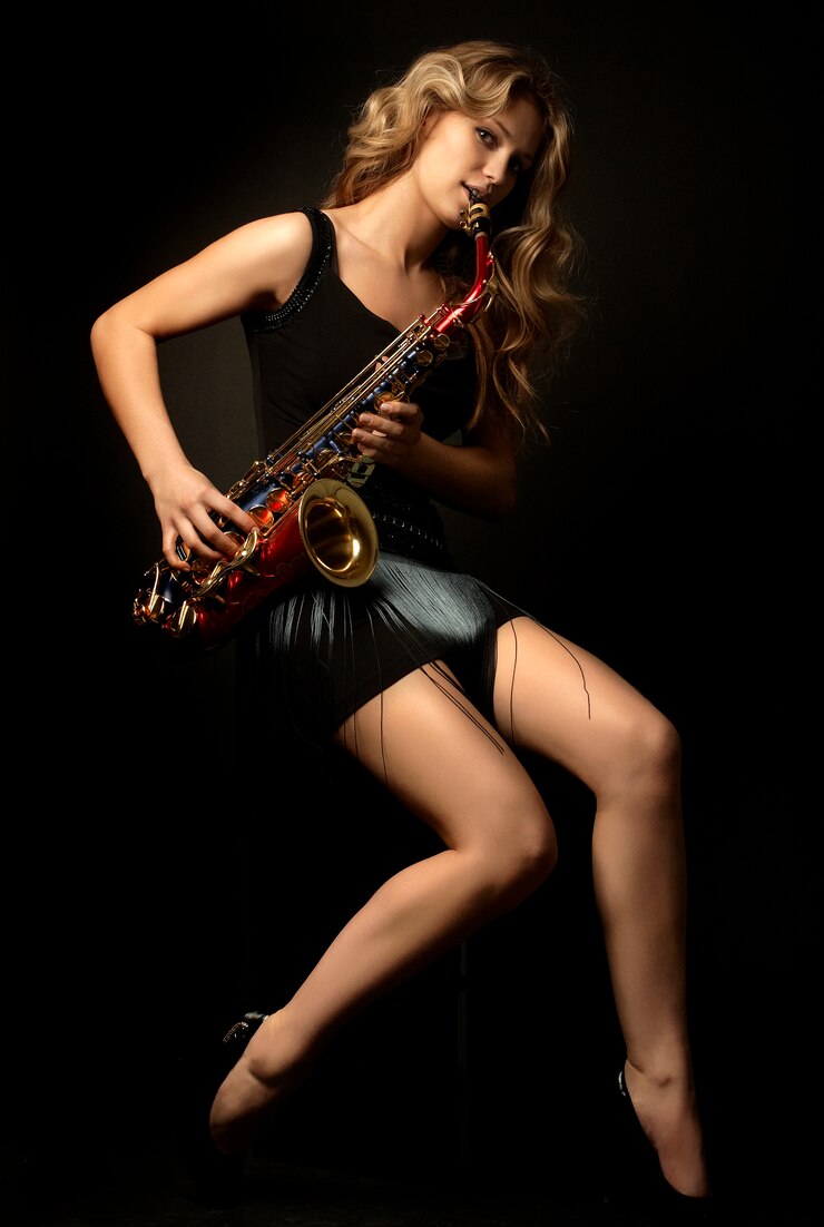 Sexy attractive blonde women model with saxophone