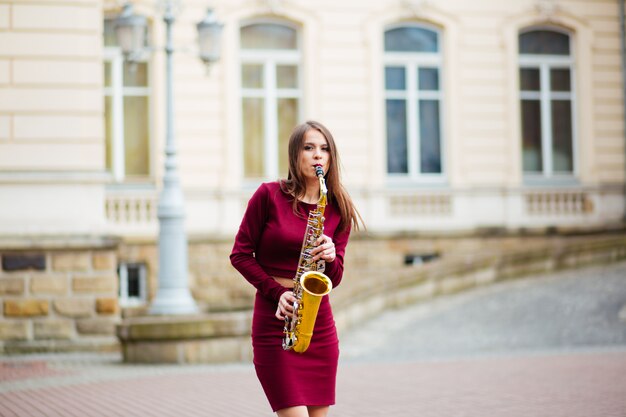 Sexy attractive woman with saxophone