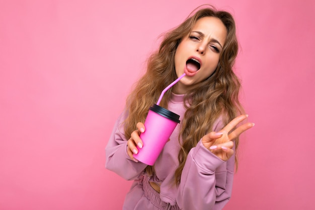 Sexy beautiful young positive blonde woman wearing pink sport clothes