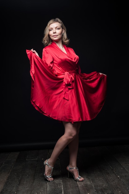 Sexy blonde in red dress in Studio