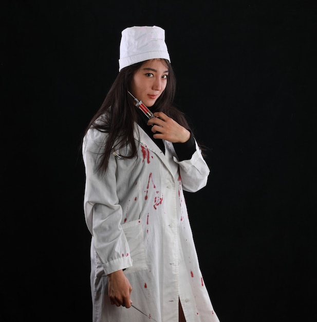 Sexy bloody nurse on black background