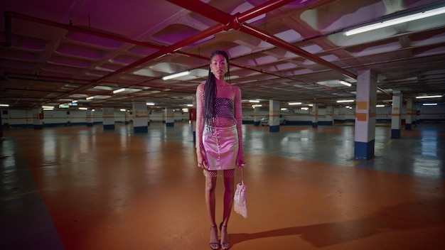 Sexy brunette posing neon light parking alone portrait african american model