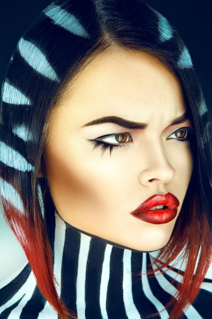 Sexy brunette with stripes on neck and hair in studio