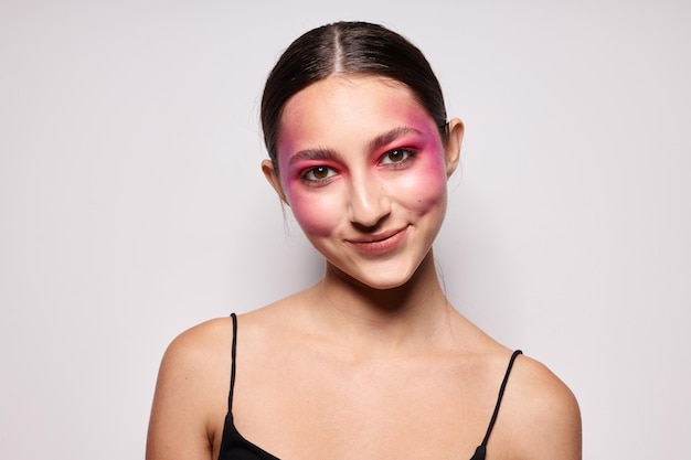 Sexy brunette woman pink face makeup posing attractive look light background unaltered