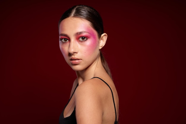 Sexy brunette woman smile makeup attractive look pink background unaltered