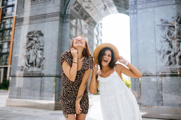 Sexy carefree women posing on street background