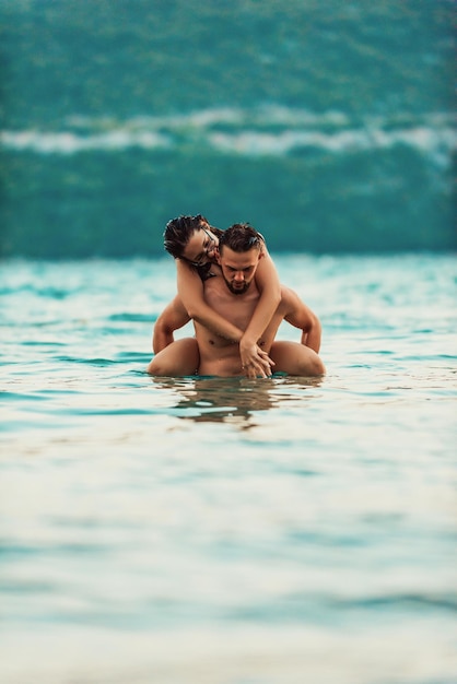 A sexy couple comes out of the sea after swimming High quality photo