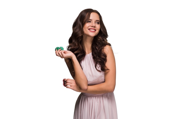 Sexy curly hair brunette posing with chips in her hands, poker concept isolation on white background