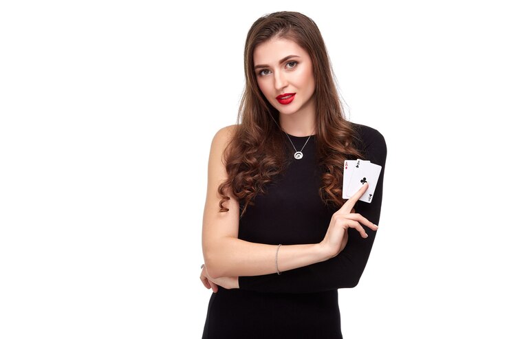 Sexy curly hair brunette posing with two aces cards in her hands poker concept isolation on white ba...