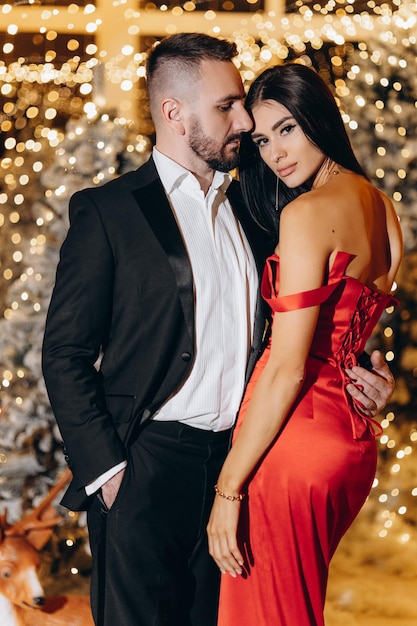 Sexy elegant couple New Year Tree