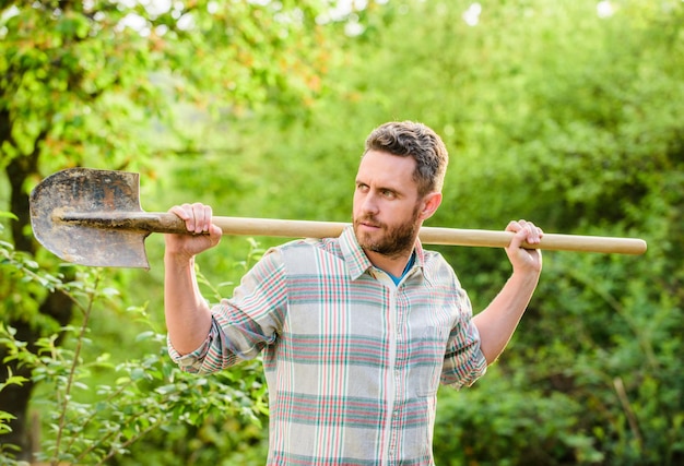 Sexy farmer hold shovel farming and agriculture cultivation Garden tools Eco farm worker Harvest happy earth day Eco living muscular ranch man Working in green environment