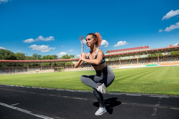 Sexy female athlete training on stadium outdoor