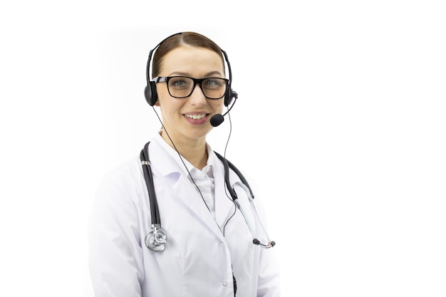 Sexy female doctor in headphones smiles, looks at camera. online patient support