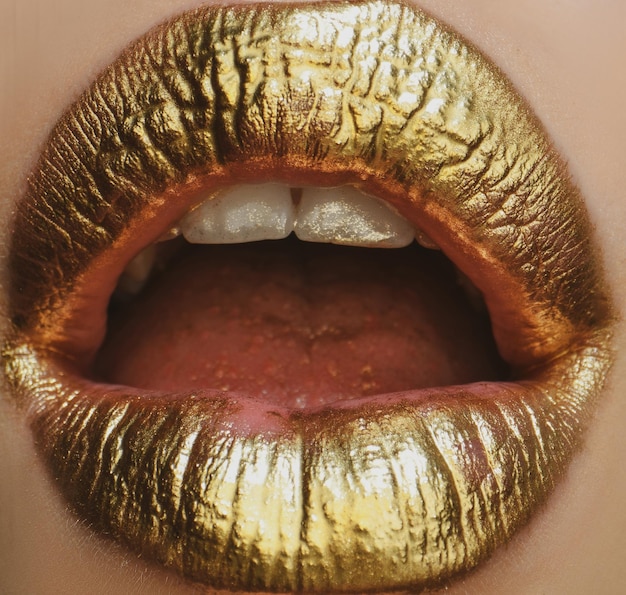 Sexy girl golden lips gold open mouth glowing gold skin makeup glitter metallic shine golden lipglos