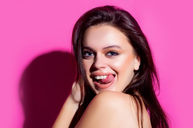 Sexy girl showing tongue. Woman emotions. Sensual female portrait. Isolated.