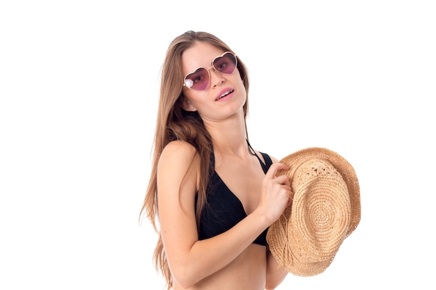 Sexy girl in sunglasses and straw in hands isolated on white background