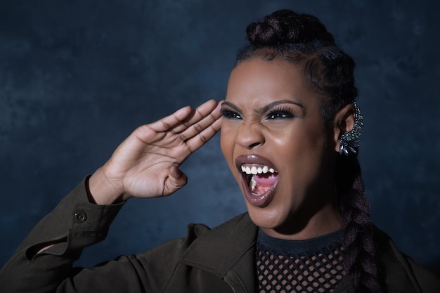 Sexy girl wearing military style khaki overall posing  in studio