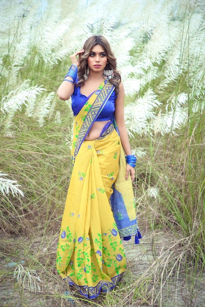 sexy girl wearing yellow saree and blue blouse in wild sugarcane