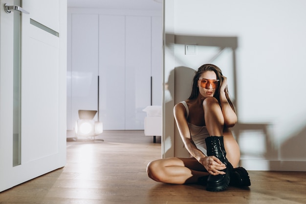 sexy girl in a white T-shirt posing on the kitchen floor