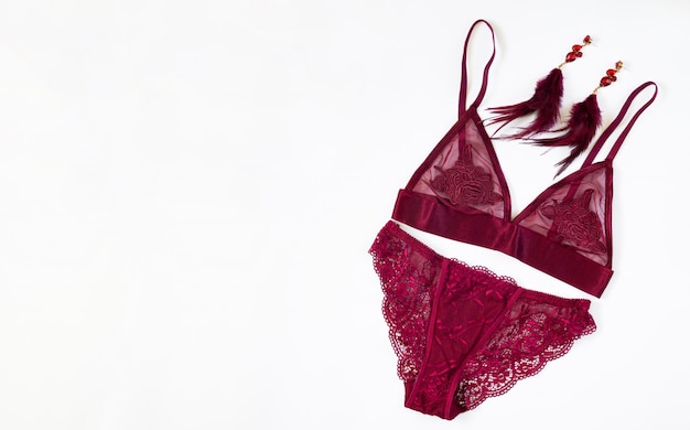 Sexy lace burgundy women's lingerie with fashion earrings isolated
