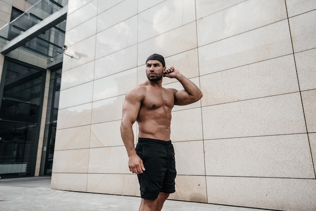 Sexy man posing topless in the hot sun. Fitness. Lifestyle