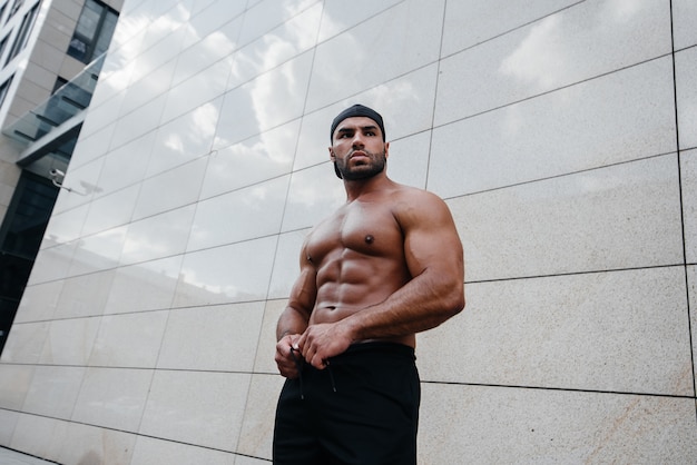 Sexy man posing topless in the hot sun. Fitness. Lifestyle