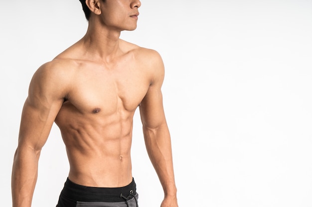 Sexy man showing muscular abdominal stand facing side