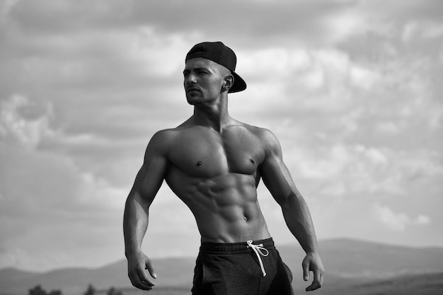 Sexy muscular man on sky background