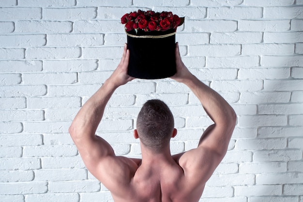 Sexy muscular man with roses