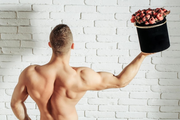 Sexy muscular man with roses