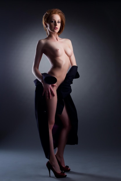 Sexy nude lady posing with undressed black coat erotic portrait