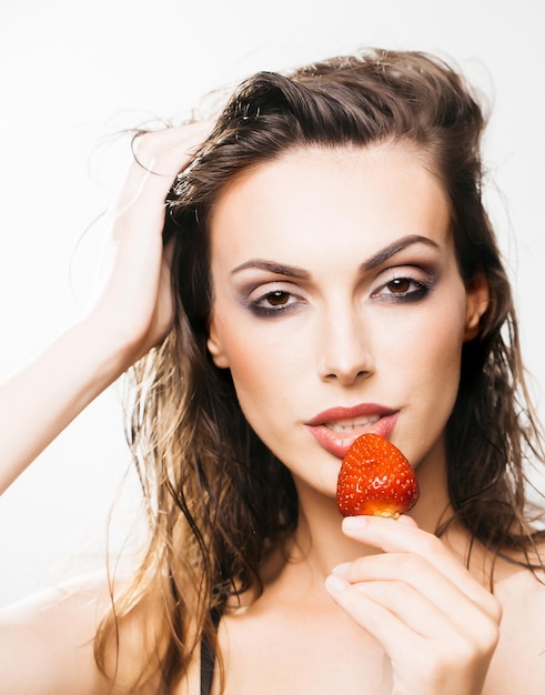 Sexy pretty woman with red strawberry