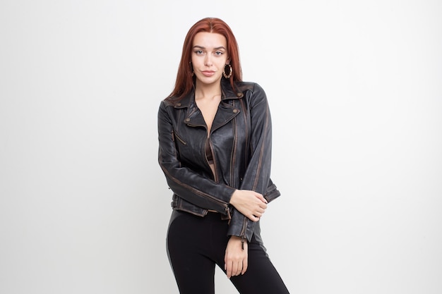 Sexy redhead girl posing in leather jacket