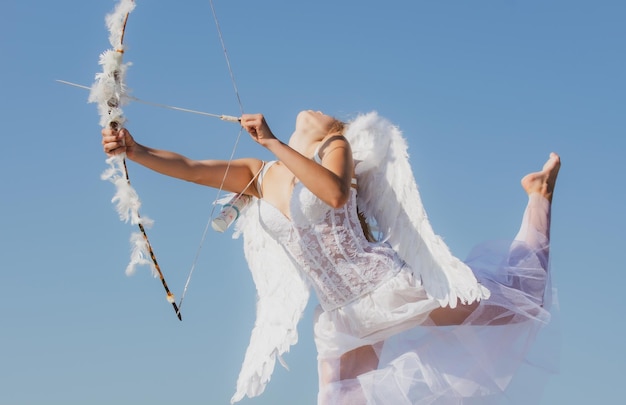 Sexy sensual angel with bow and arrow cupid girl in white dress portrait of sweet angelic girl happy...